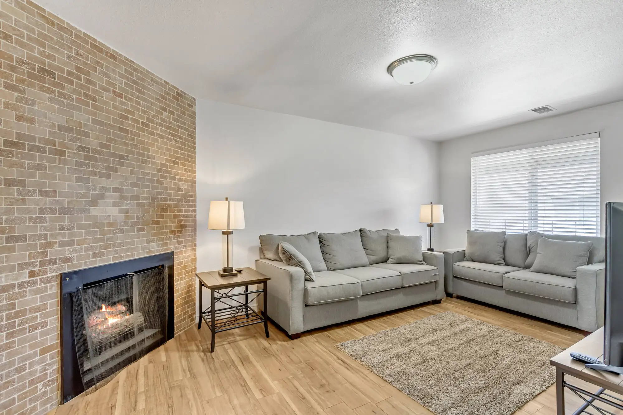 Living room with brick fireplace and seating